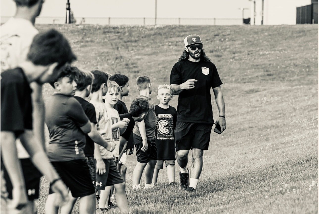 Coach Keller leading young athletes