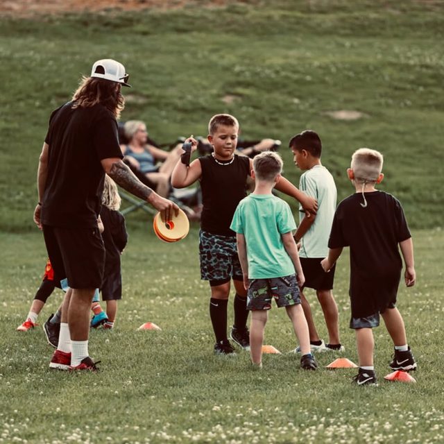 Kellz Camp post — Coach Keller running a cone drill with young athletes