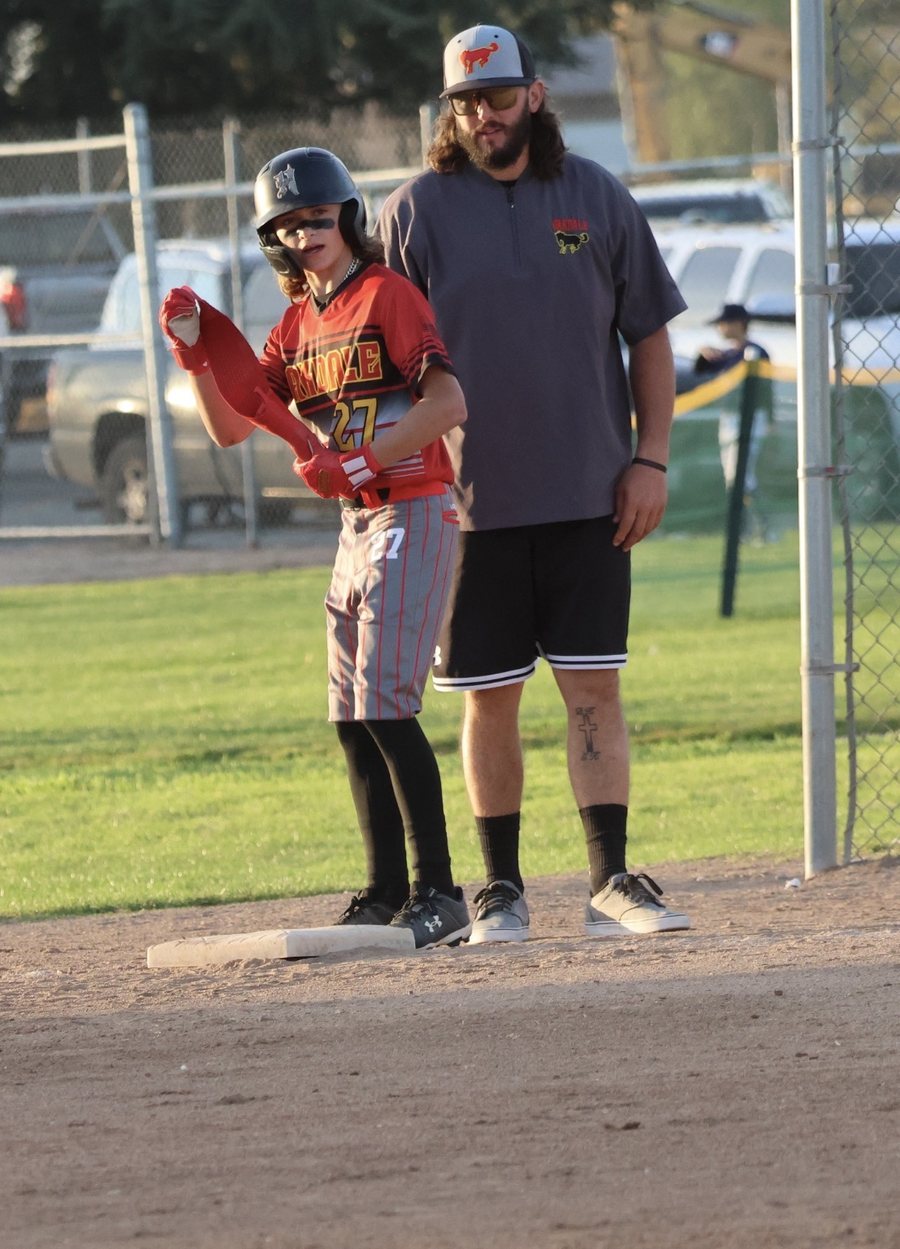 Coach Keller coaching a young baseball player